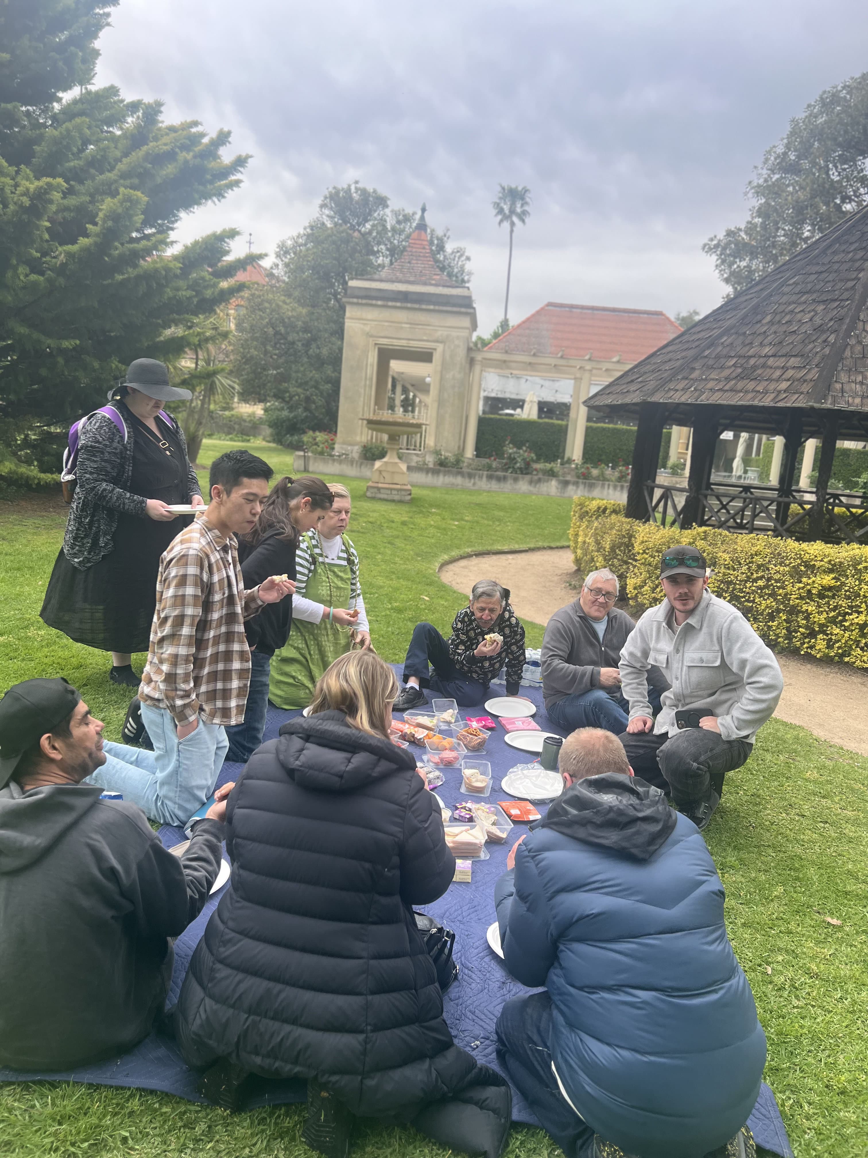 The Lyft Community crew around a picnic rug in the Botanic Gardens.